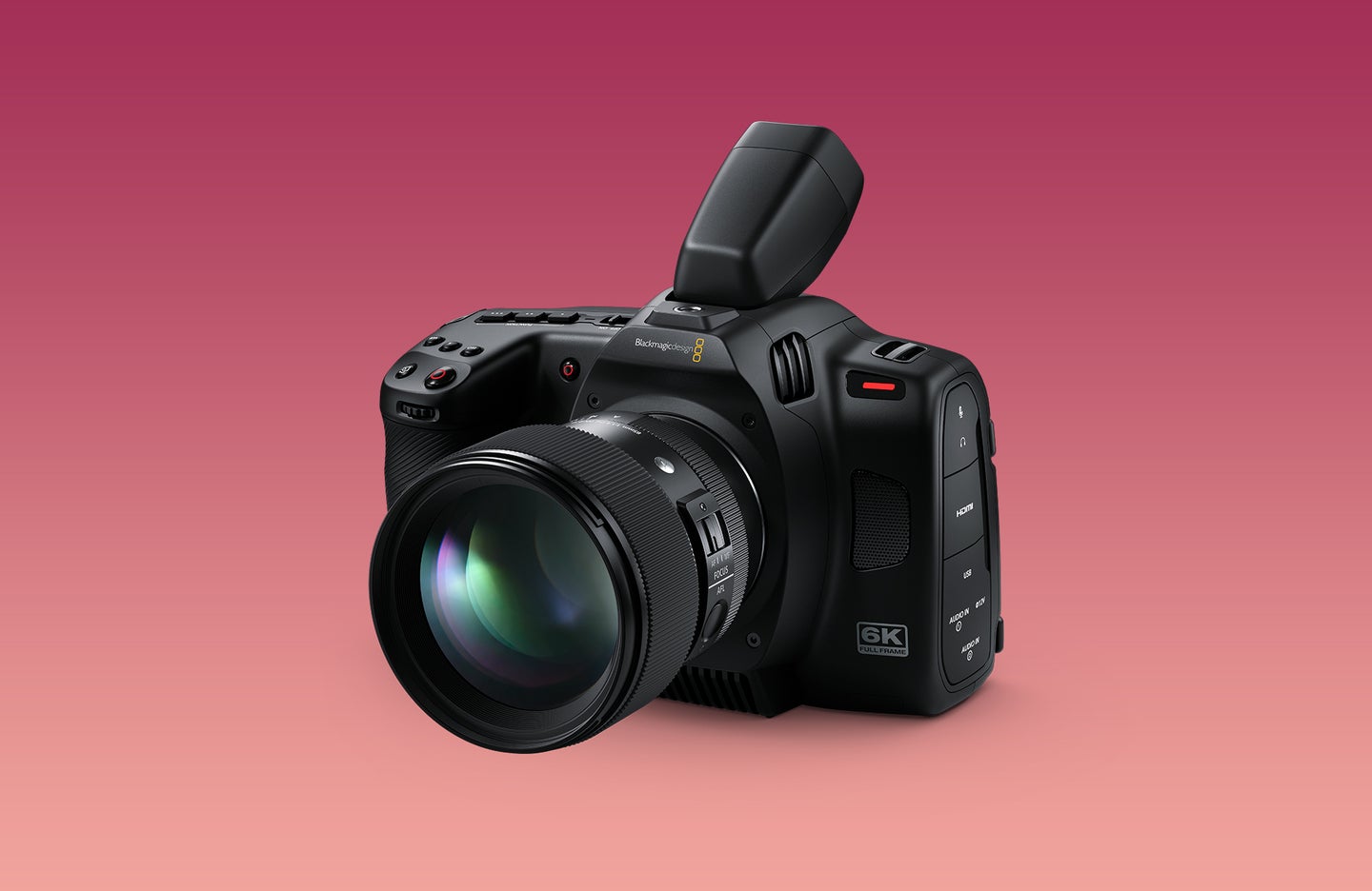 Blackmagic Cinema Camera 6K against a background fading rom light peach to dark pink