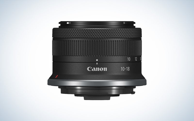The Canon RF-S 10-18mm f/4.5-6.3 compact camera lens is placed against a white background.