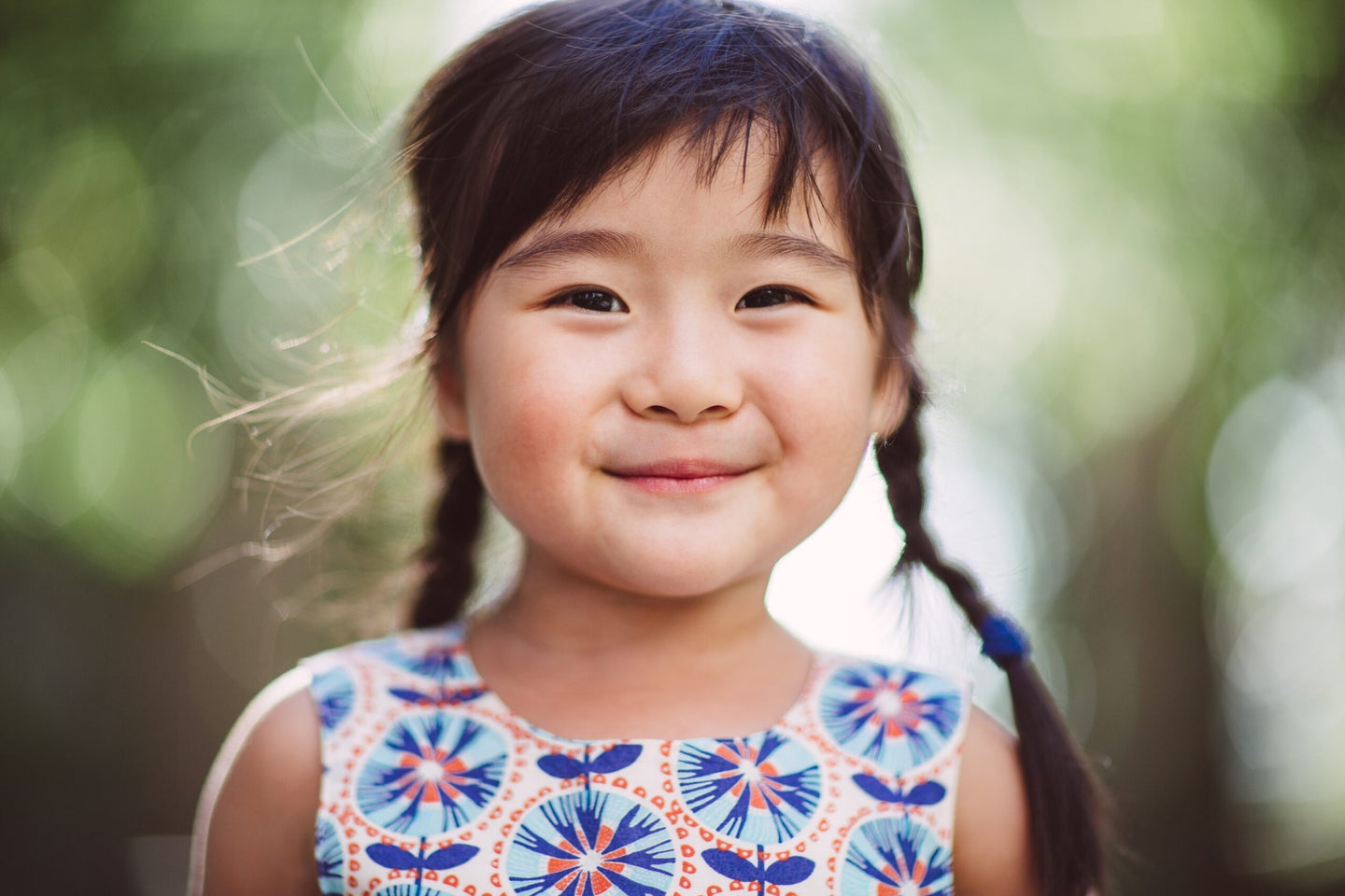 A child smiling with an out of focus background.