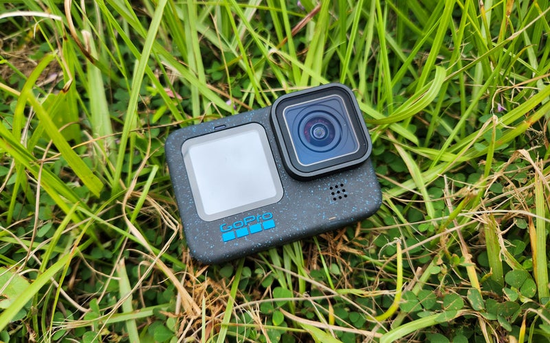 The GoPro Hero12 Black laying in the grass.